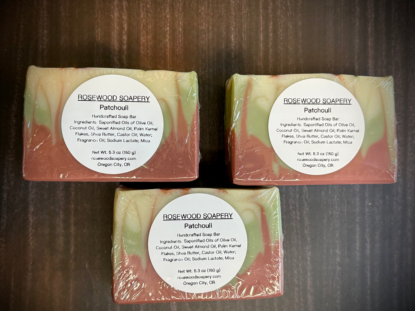 3 bars of packaged soap with labels.