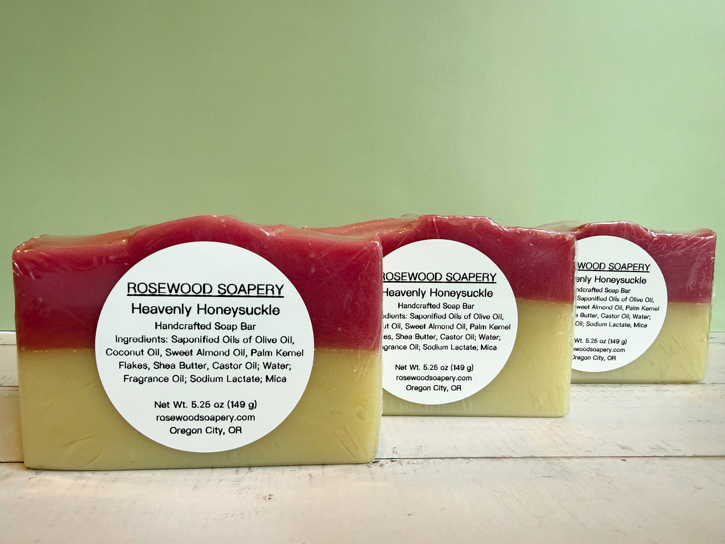 Three bars of soap with Rosewood Soapery labels on a light green background. 